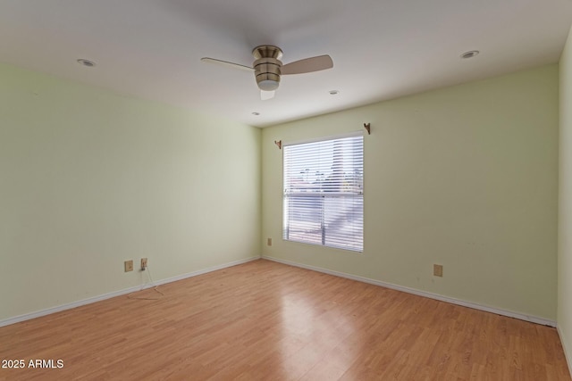 empty room featuring ceiling fan and light hardwood / wood-style floors