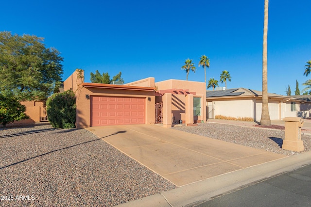 pueblo-style home featuring a garage