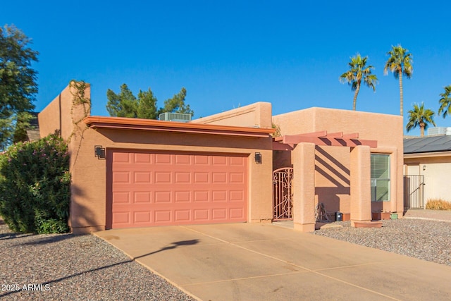 view of front of house with central air condition unit and a garage