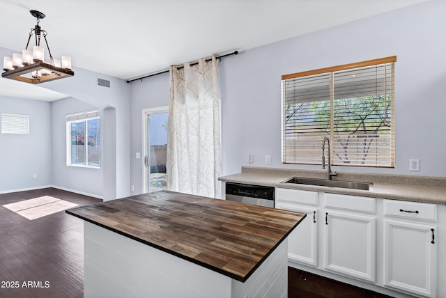 kitchen featuring visible vents, a sink, dark wood-style floors, wooden counters, and dishwasher