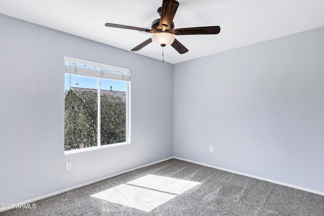 empty room featuring baseboards, carpet, and a ceiling fan