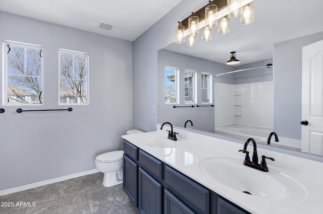 bathroom with a wealth of natural light, visible vents, and a sink