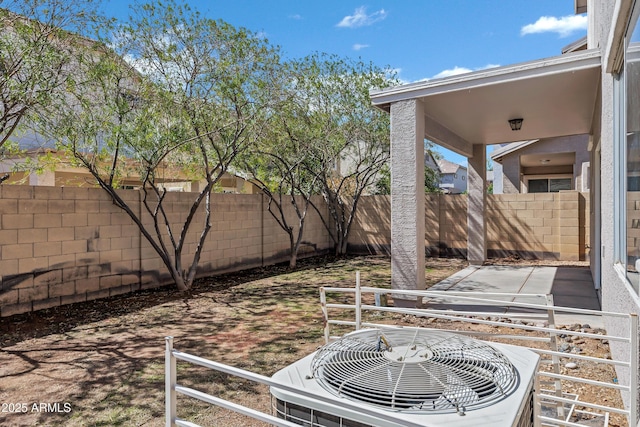 view of patio / terrace with central air condition unit and a fenced backyard