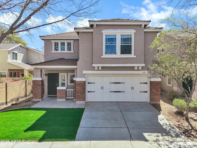 view of front of home with stucco siding, a garage, driveway, and fence