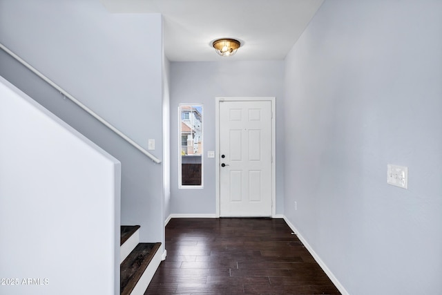 entrance foyer featuring stairs, wood finished floors, and baseboards