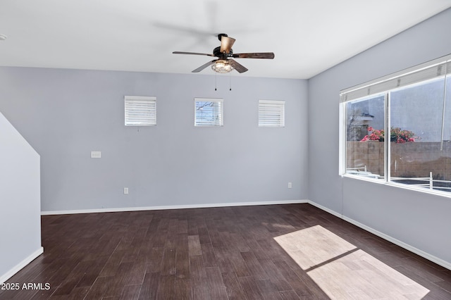 unfurnished room featuring baseboards, wood finished floors, and a ceiling fan