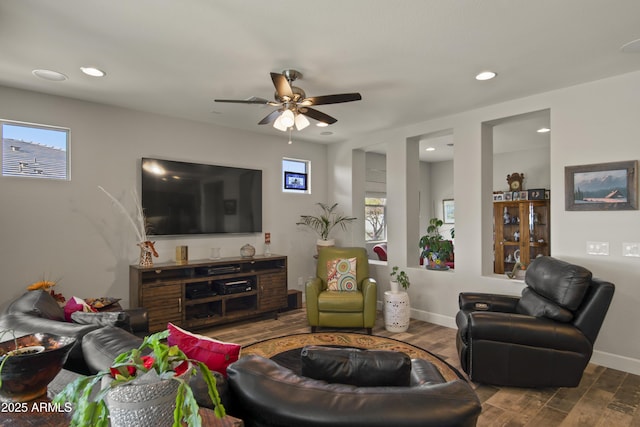 living area featuring recessed lighting, plenty of natural light, wood finished floors, and baseboards