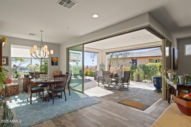 dining area featuring plenty of natural light, wood finished floors, and visible vents