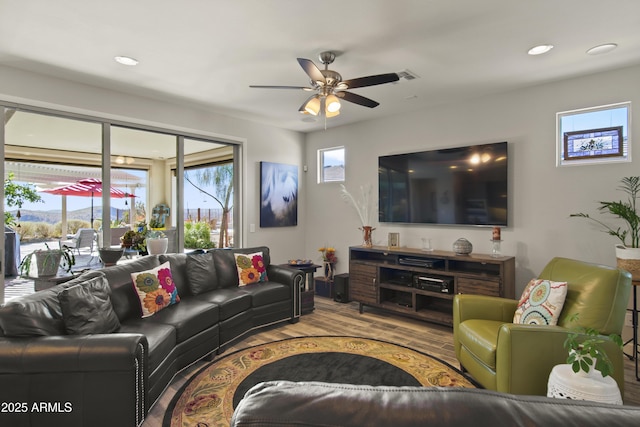 living room with recessed lighting, a ceiling fan, and light wood-style floors