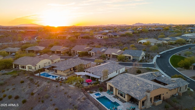 aerial view at dusk featuring a residential view