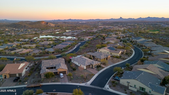 aerial view at dusk with a residential view and a mountain view