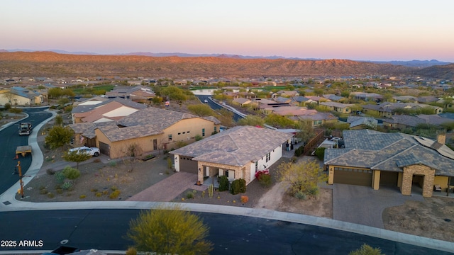 aerial view at dusk with a residential view and a mountain view