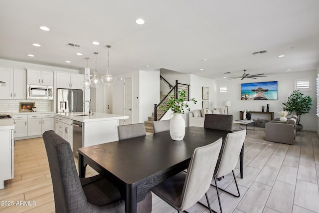 dining space featuring sink and ceiling fan