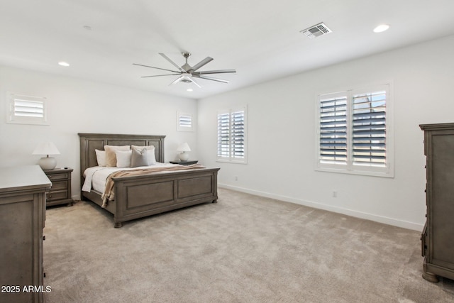 bedroom with ceiling fan and light carpet