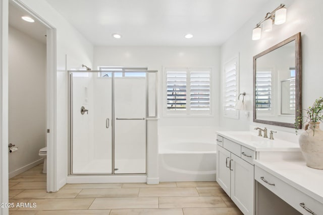 full bathroom with plus walk in shower, vanity, and toilet