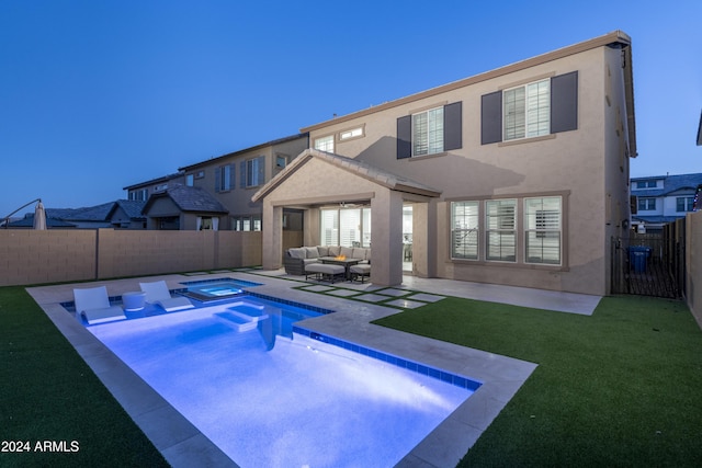 view of swimming pool with outdoor lounge area, a yard, a patio area, and an in ground hot tub