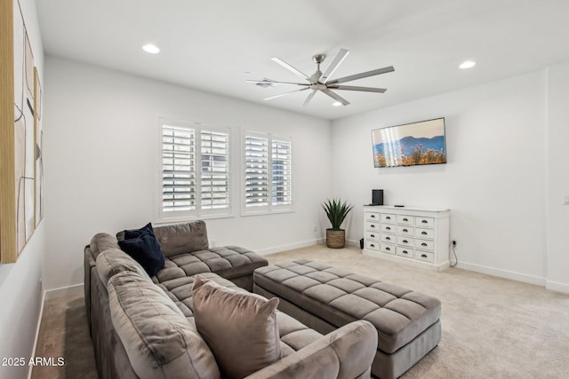 carpeted living room with ceiling fan