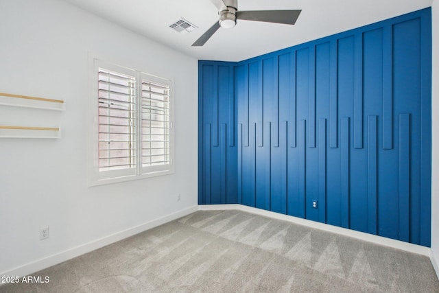 spare room with carpet floors and ceiling fan