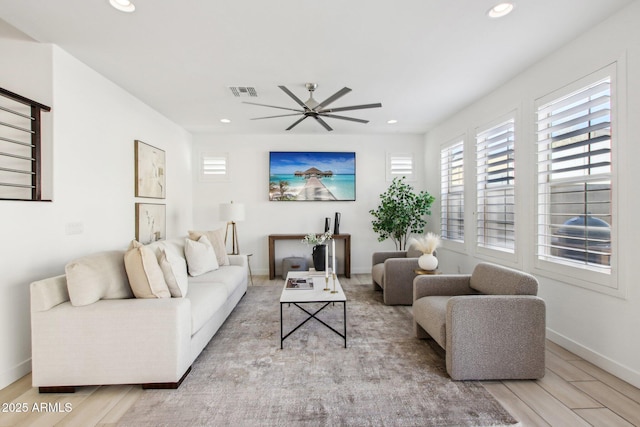 living room featuring ceiling fan and light hardwood / wood-style flooring