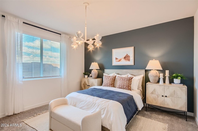 bedroom with baseboards, a chandelier, and carpet flooring