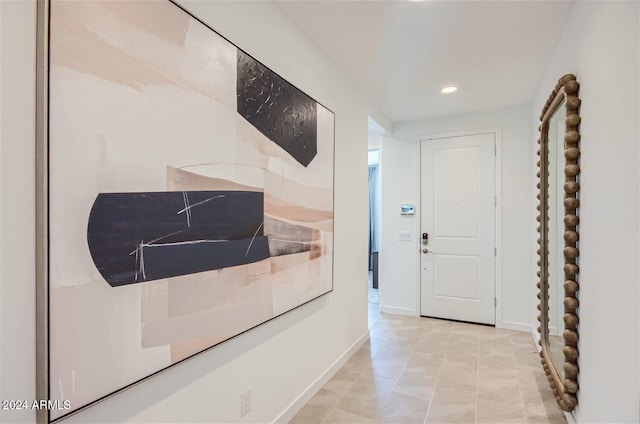 hallway featuring recessed lighting and baseboards