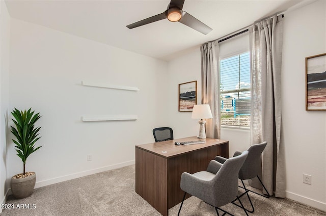 carpeted office with baseboards and ceiling fan