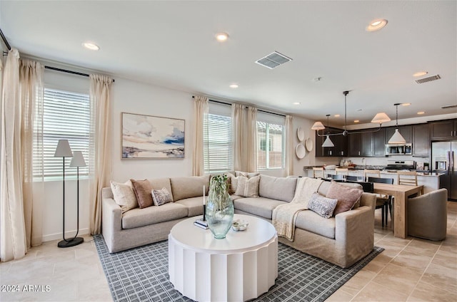 living room featuring recessed lighting, visible vents, and light tile patterned flooring