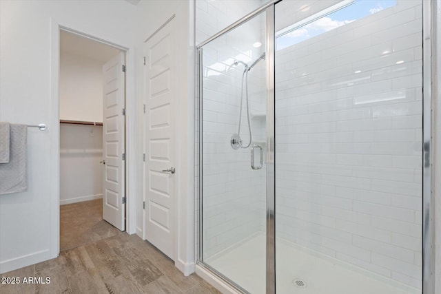 bathroom with hardwood / wood-style floors and walk in shower