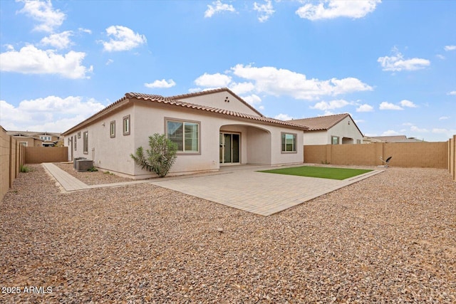 rear view of property featuring central AC and a patio