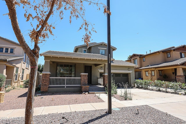 15365 W Valentine St, Surprise, AZ 85379 - view of front facade featuring a porch, stucco siding, an attached garage, and driveway