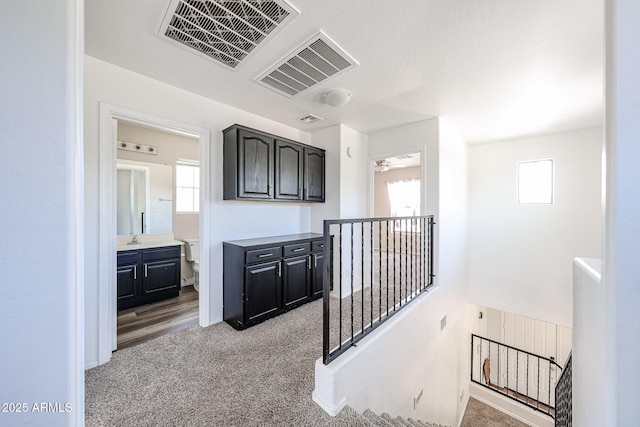 15365 W Valentine St, Surprise, AZ 85379 - hallway with an upstairs landing, carpet flooring, and a sink