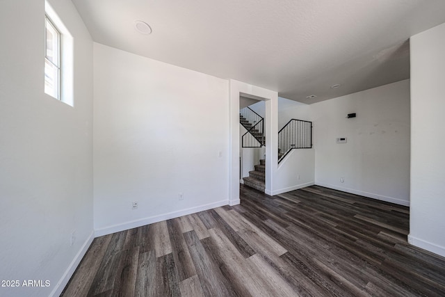 15365 W Valentine St, Surprise, AZ 85379 - unfurnished room featuring dark wood-type flooring, stairway, and baseboards