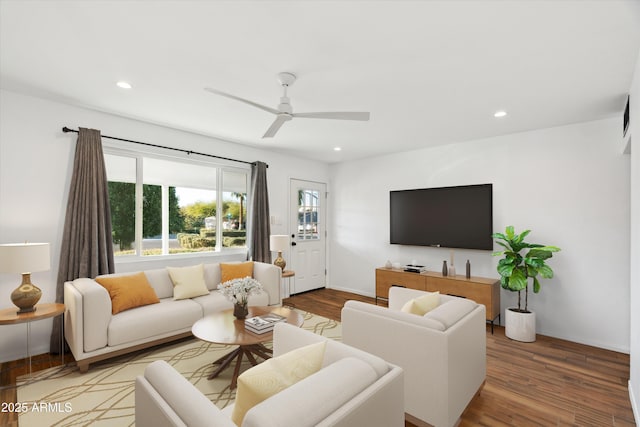 living room with hardwood / wood-style flooring and ceiling fan