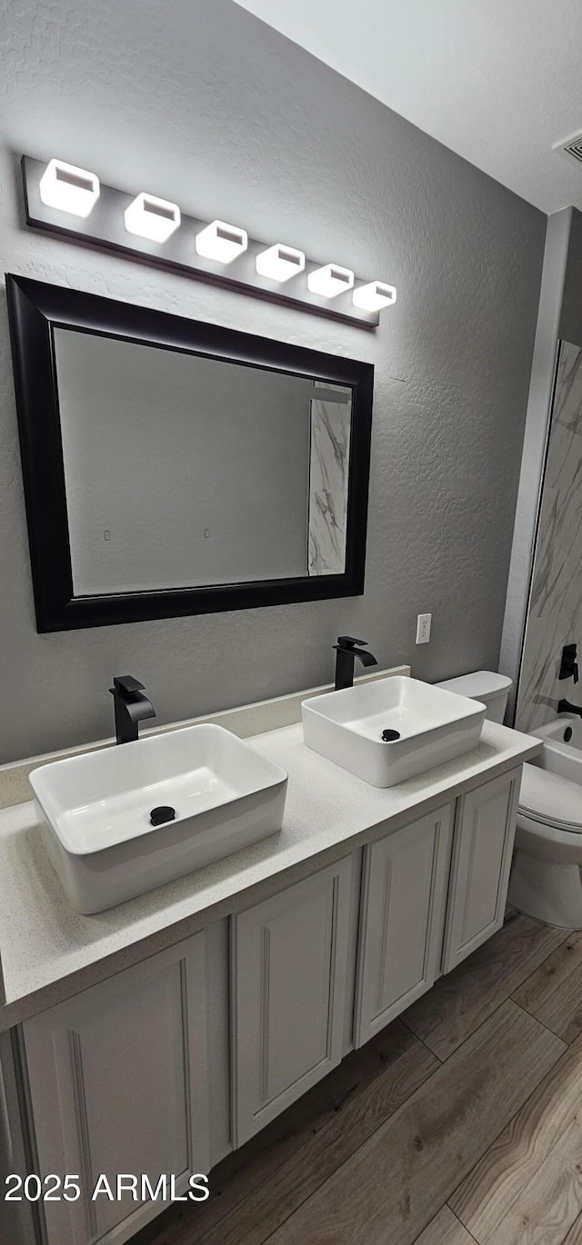 full bathroom featuring vanity, shower / bathtub combination, and toilet