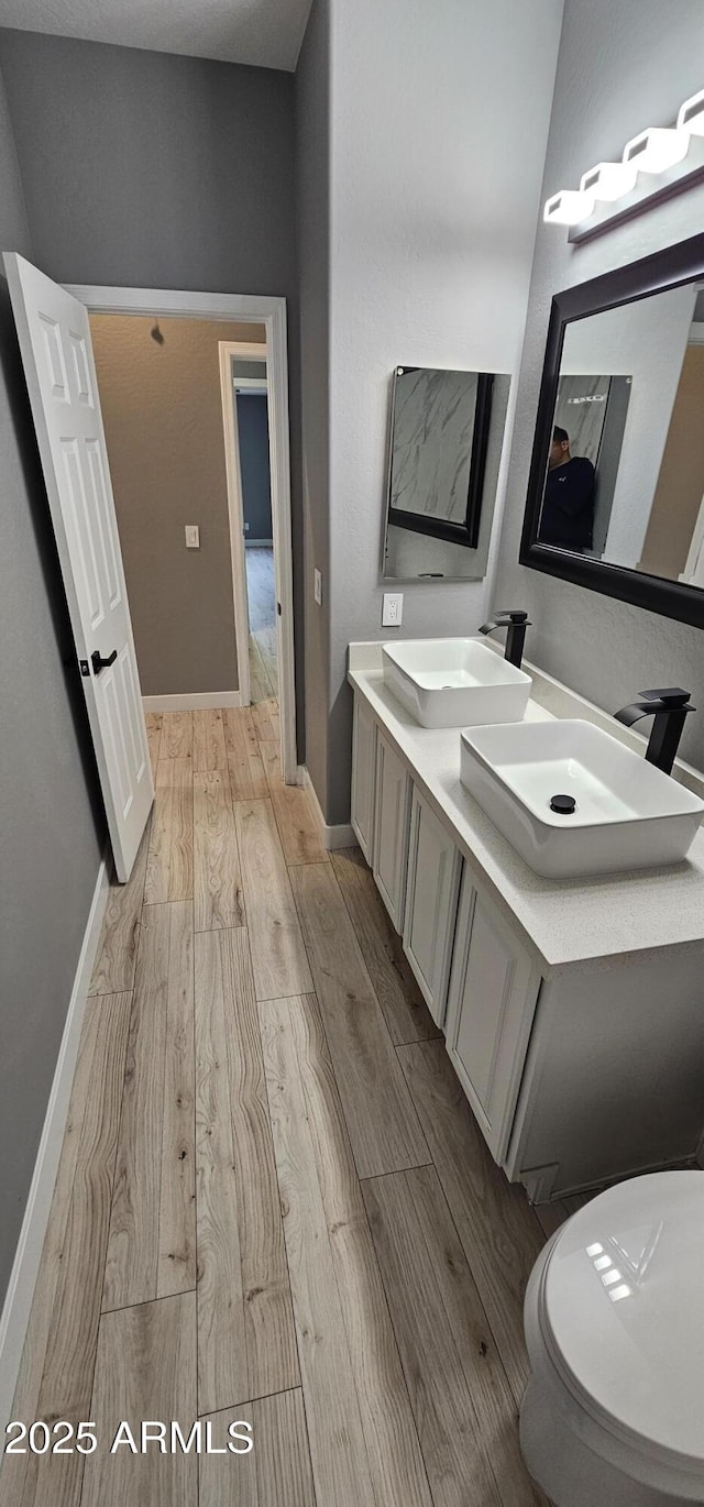 bathroom featuring hardwood / wood-style floors, vanity, and toilet