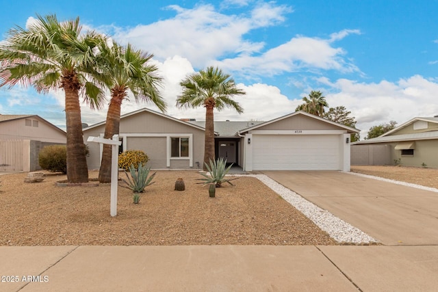 ranch-style house featuring concrete driveway and a garage