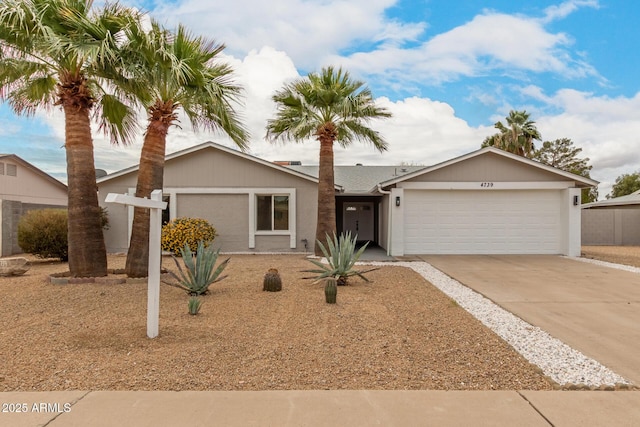 single story home featuring concrete driveway and a garage