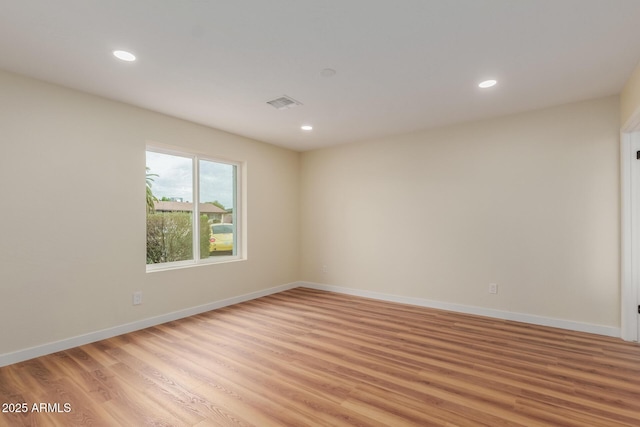 spare room with visible vents, recessed lighting, baseboards, and light wood-style floors