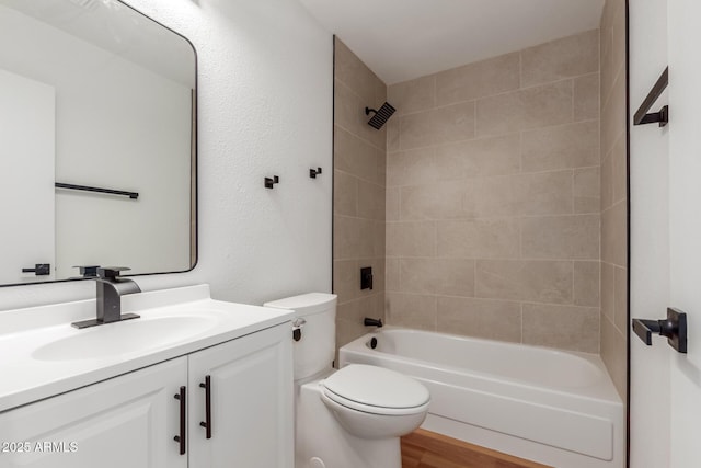 full bath with tub / shower combination, toilet, vanity, and wood finished floors