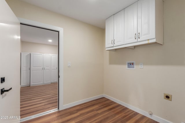 washroom featuring cabinet space, hookup for an electric dryer, baseboards, and wood finished floors