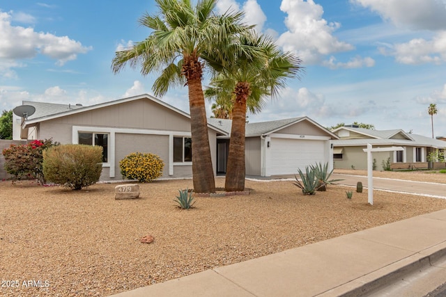 ranch-style home featuring concrete driveway and a garage