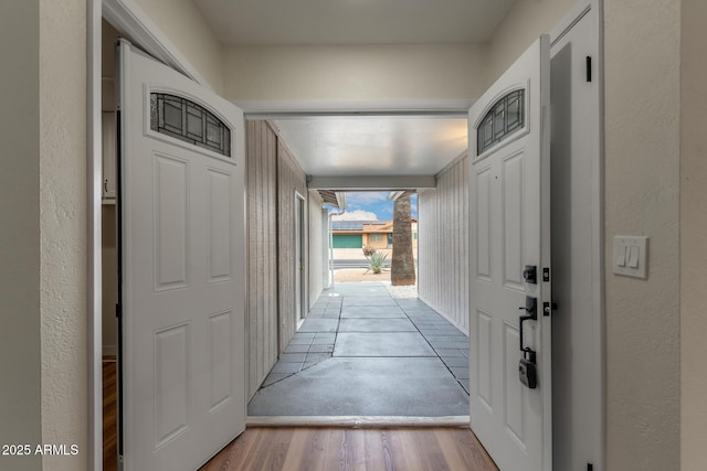 interior space with wood finished floors and a textured wall