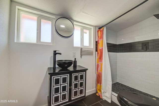 520 S Macdonald, Mesa, AZ 85210 - full bathroom with tiled shower, vanity, plenty of natural light, and a textured ceiling