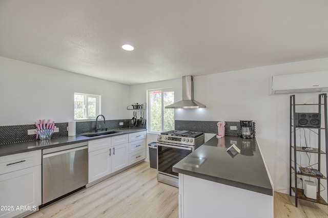 520 S Macdonald, Mesa, AZ 85210 - kitchen with appliances with stainless steel finishes, wall chimney range hood, a sink, dark countertops, and decorative backsplash