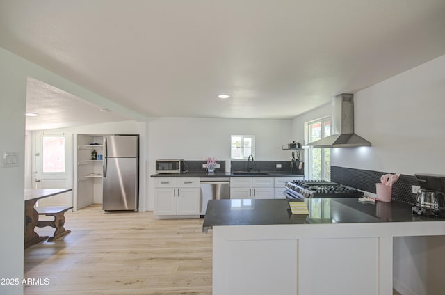 520 S Macdonald, Mesa, AZ 85210 - kitchen featuring stainless steel appliances, wall chimney range hood, a sink, dark countertops, and light wood-style floors