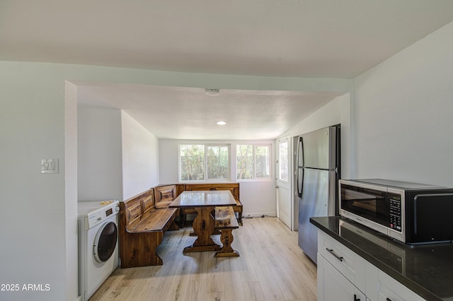 520 S Macdonald, Mesa, AZ 85210 - kitchen with stainless steel appliances, washer / dryer, light wood-style floors, and white cabinetry