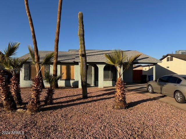 single story home featuring a carport