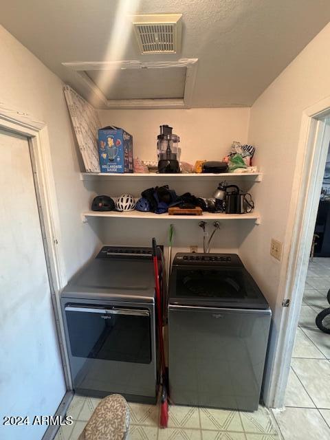 clothes washing area featuring separate washer and dryer