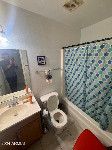 bathroom featuring toilet, vanity, and tile patterned floors