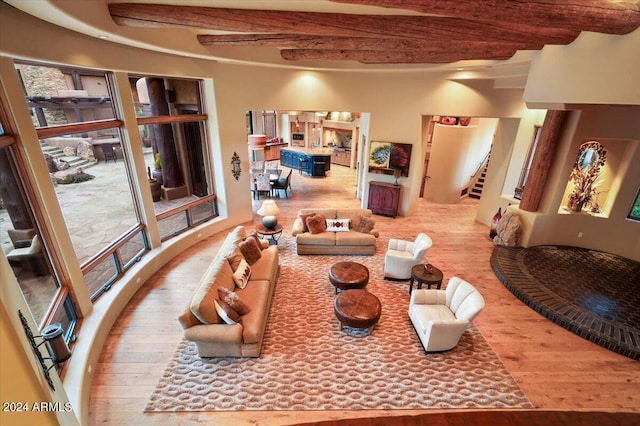 dining room featuring beamed ceiling and hardwood / wood-style floors